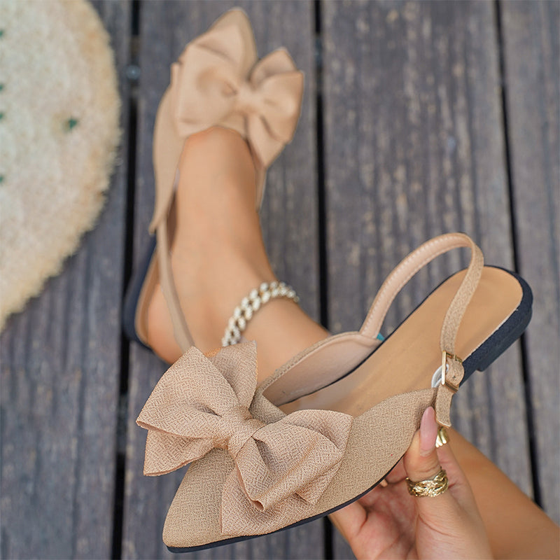 Elegant flat shoes with a bow and ankle strap
